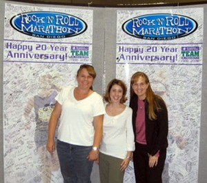 Becca, Sharon, and Tonya in front of the TNT wall of signatures at the expo